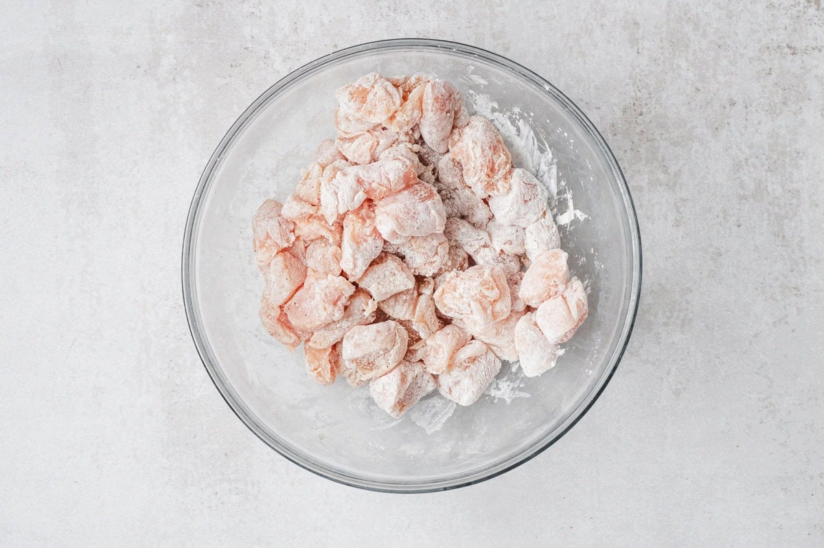 Raw chicken pieces tossed with cornstarch, salt and pepper.