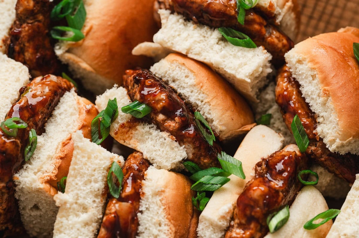 Pork sliders with green onion garnish.