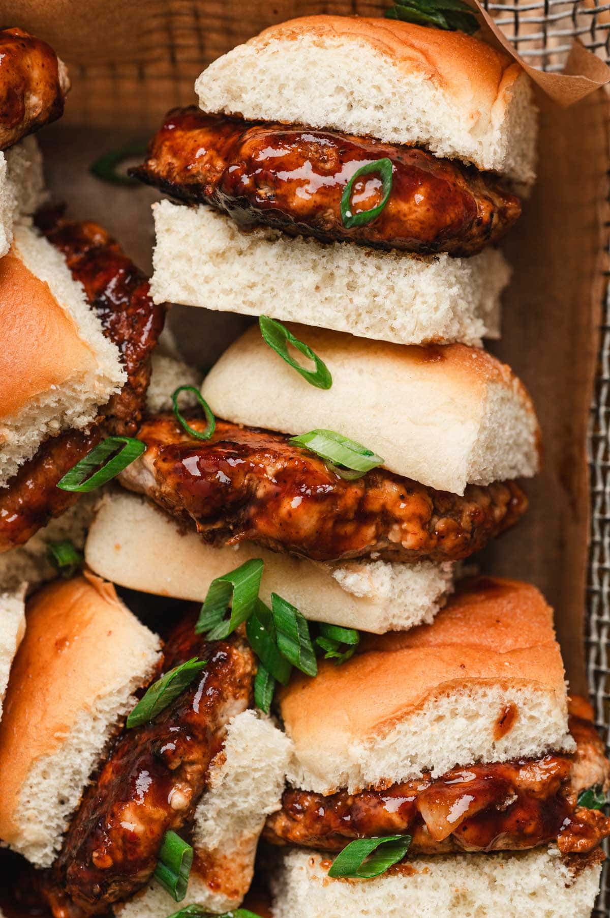 Hawaiian pork sliders with green onion garnish.