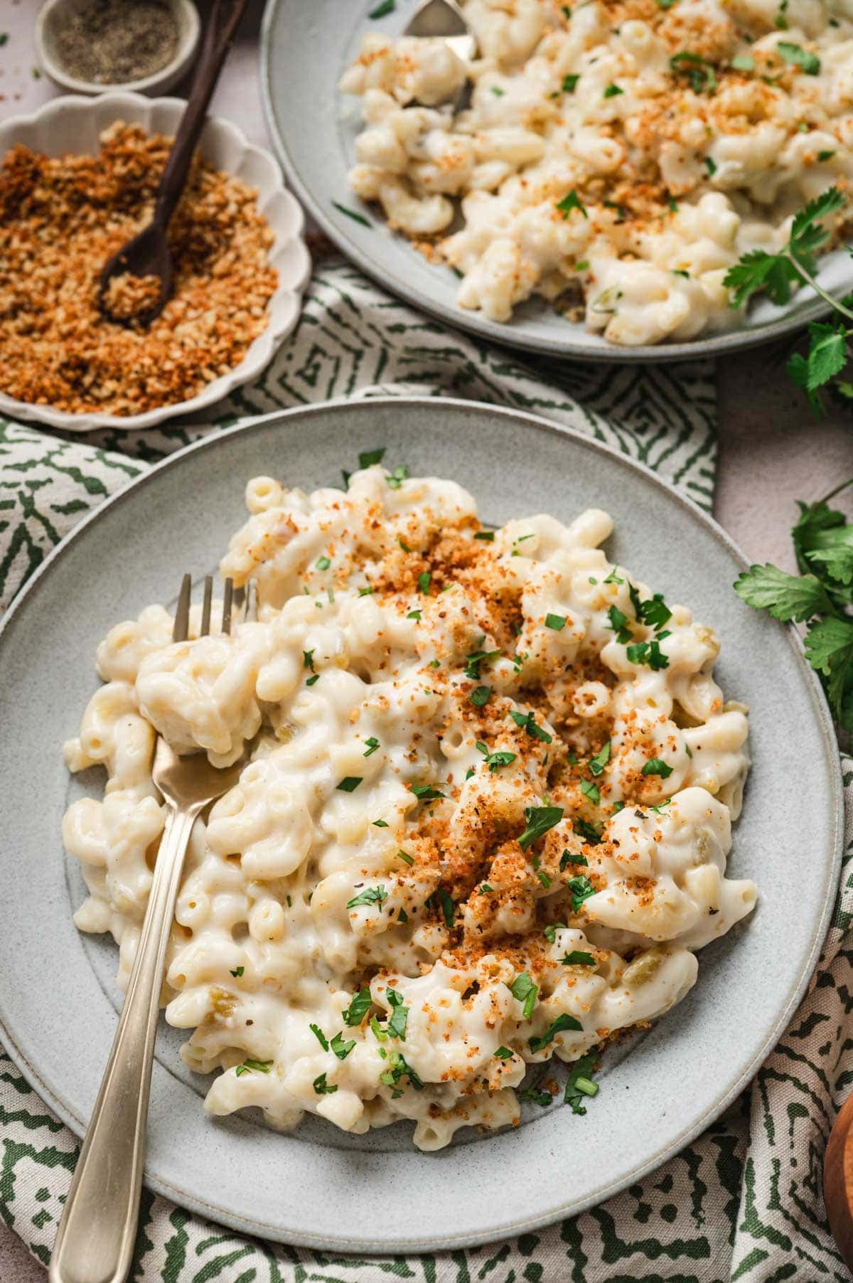 Plate of green chile mac and cheese with panko breadcrumbs on top.