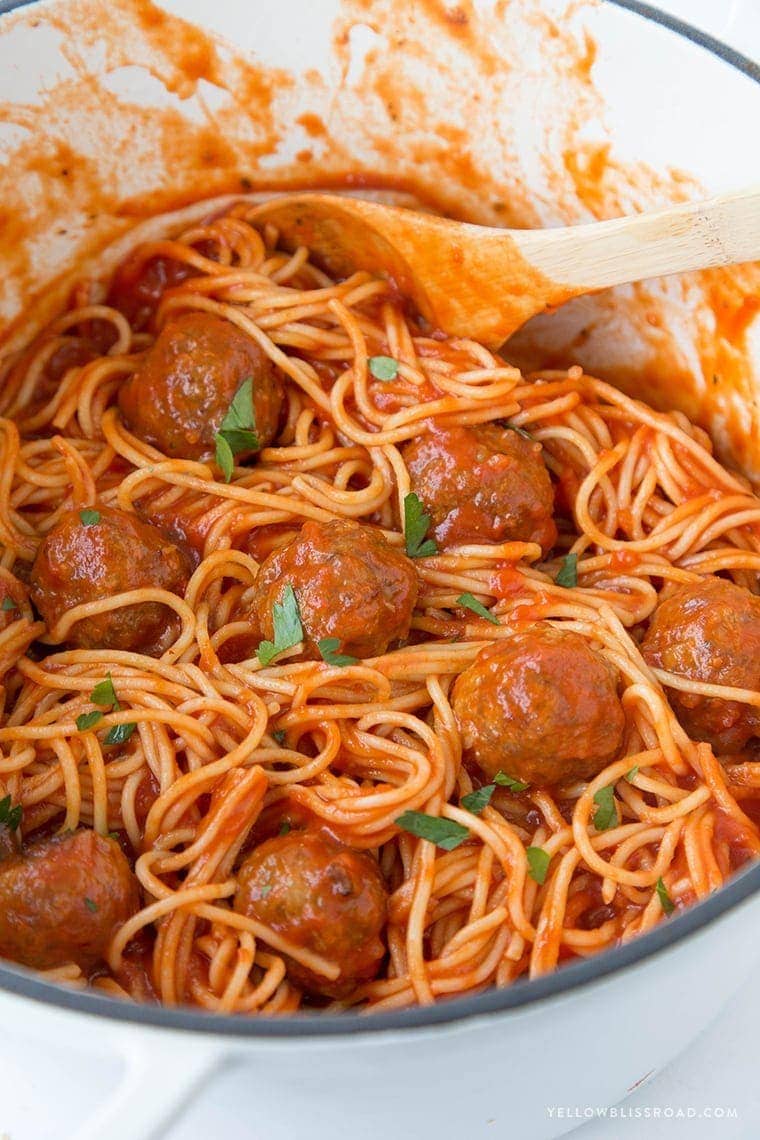 A big pot of spaghetti with meatballs and sauce