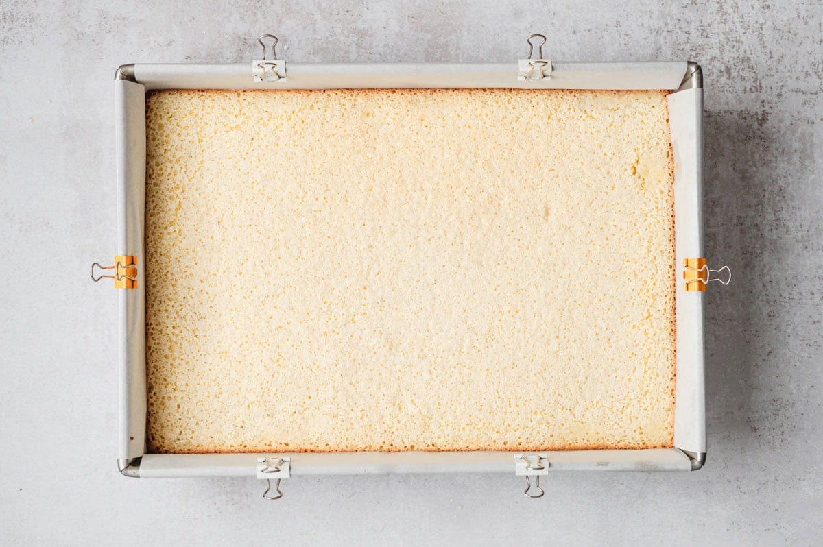 Baked lemon bars in parchment lined pan.