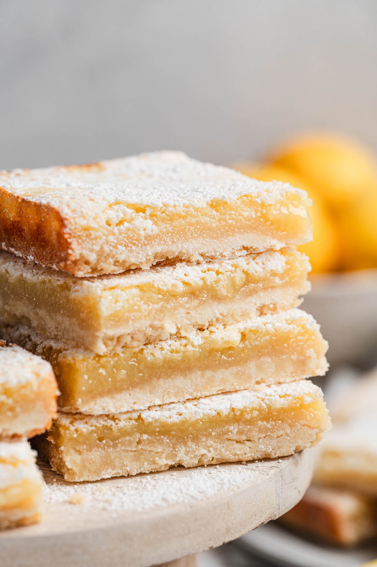 Stack of lemon bars dusted with powdered sugar.