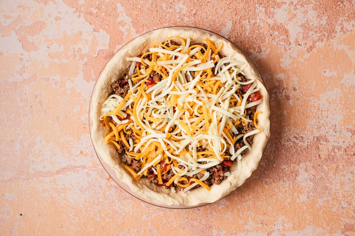 Unbaked taco pie with cheese topping