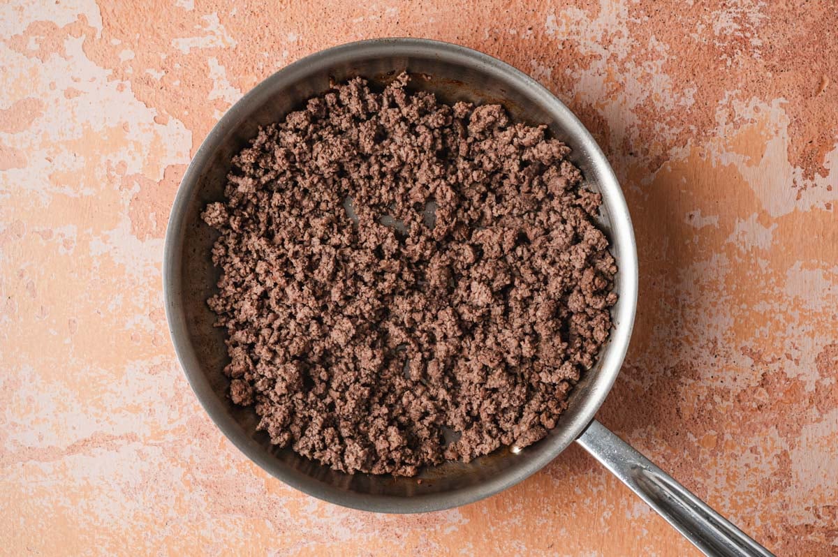 Ground beef in a saute pan.