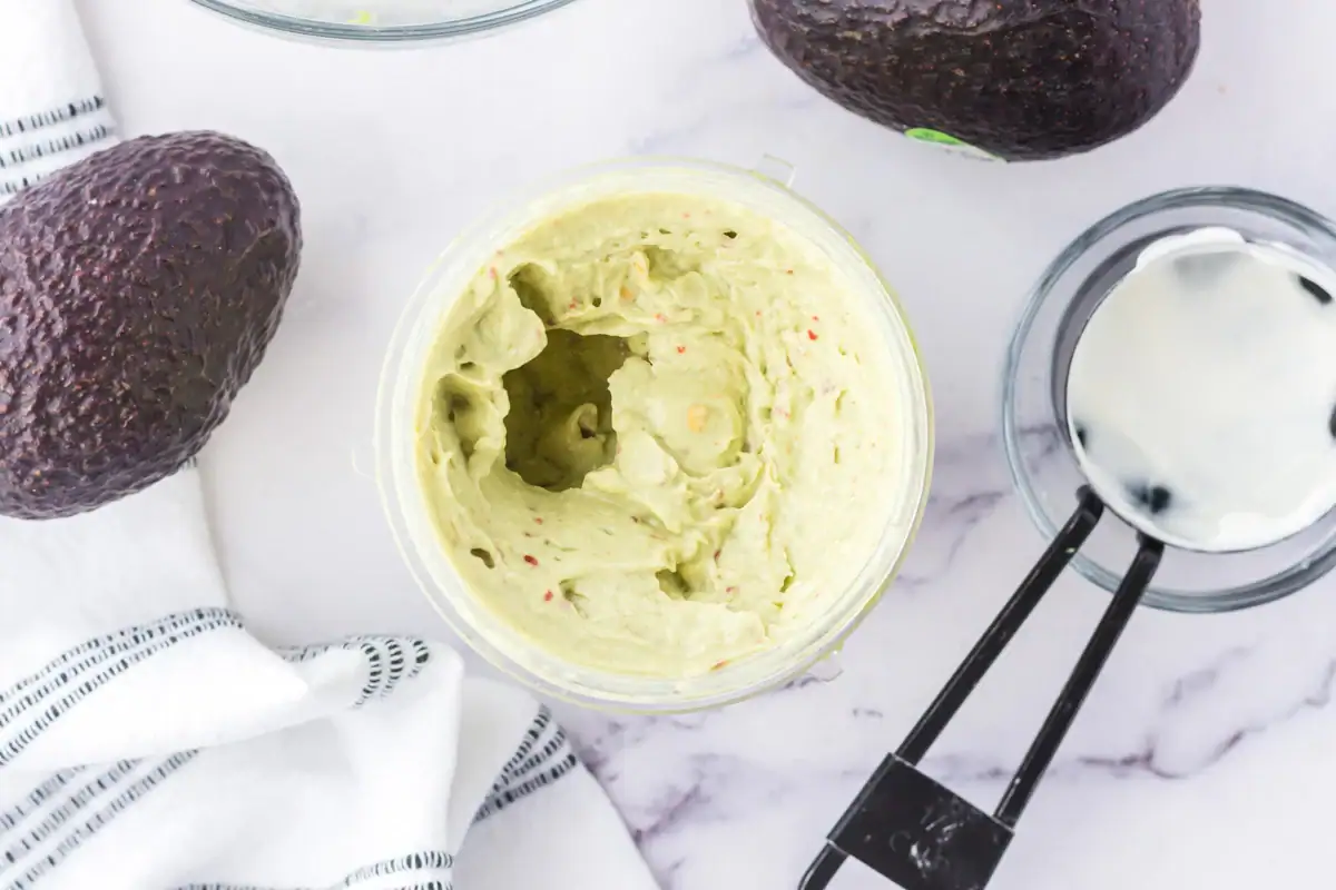 Blended avocado crema in a food processor