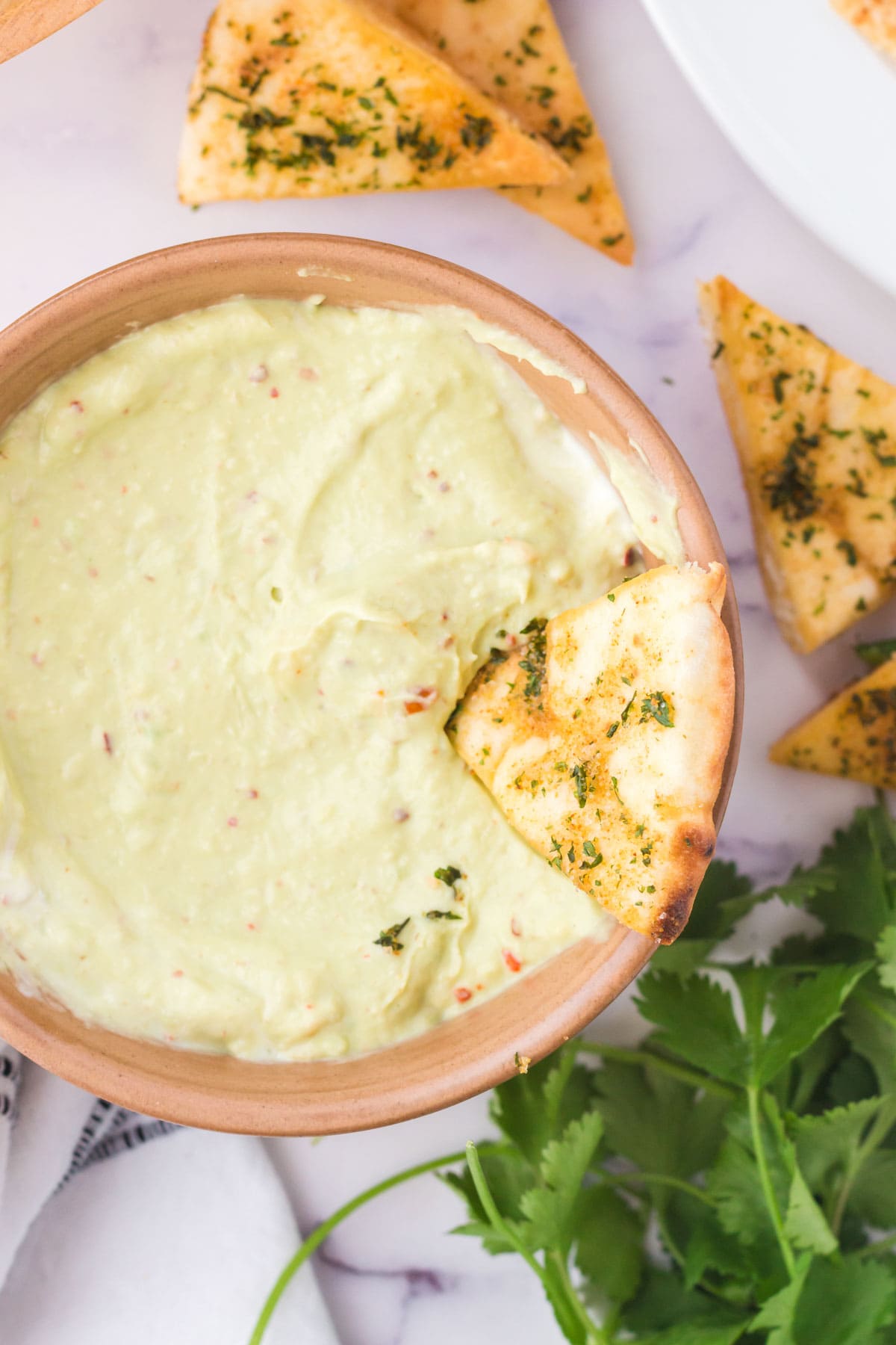 Avocado crema in a bowl with chips