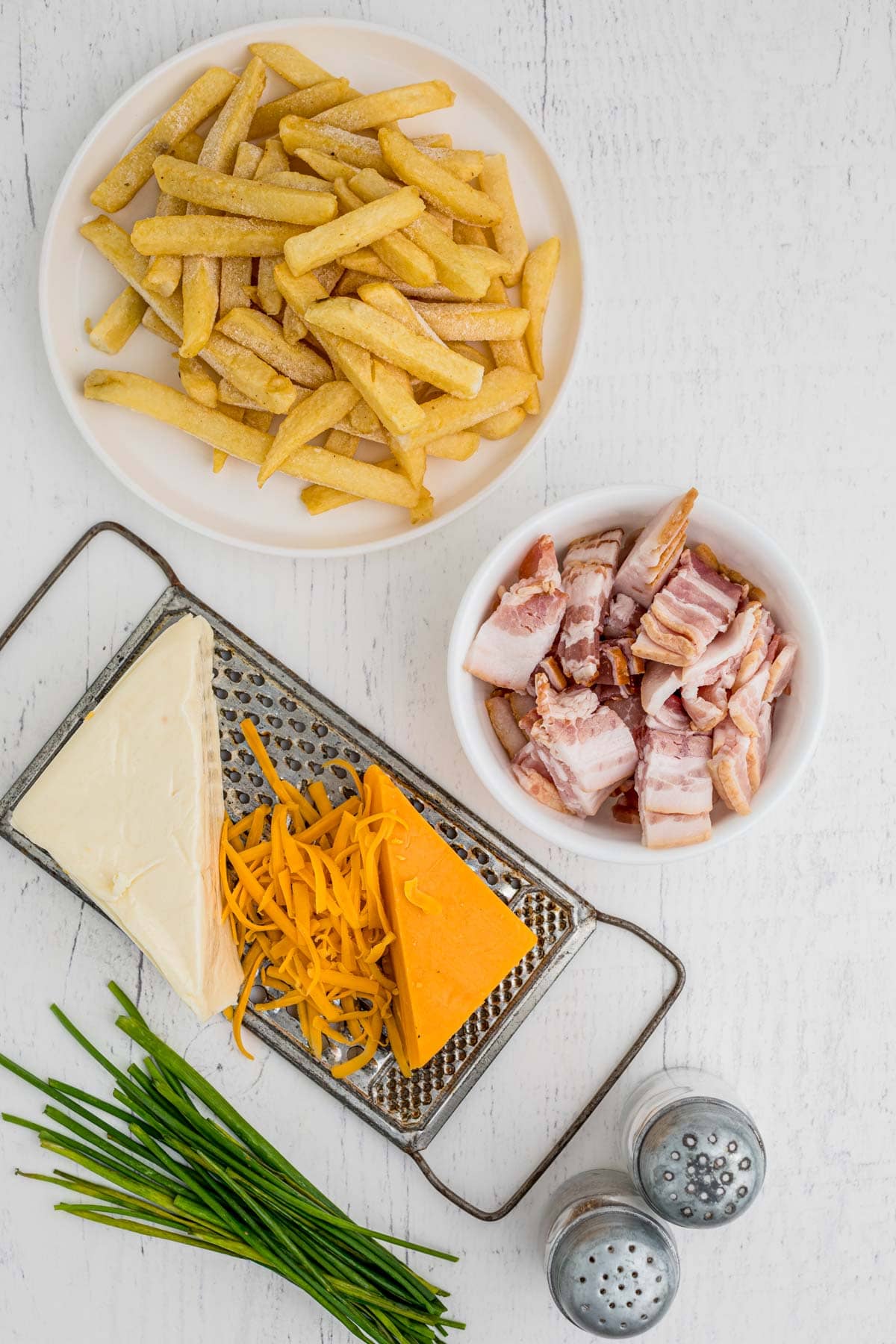 Ingredients for loaded cheese fries on a counter