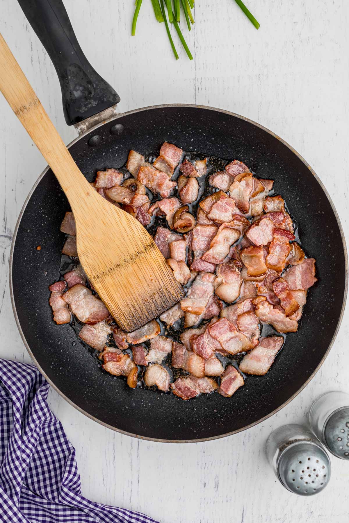 Chopped bacon cooking in a skillet