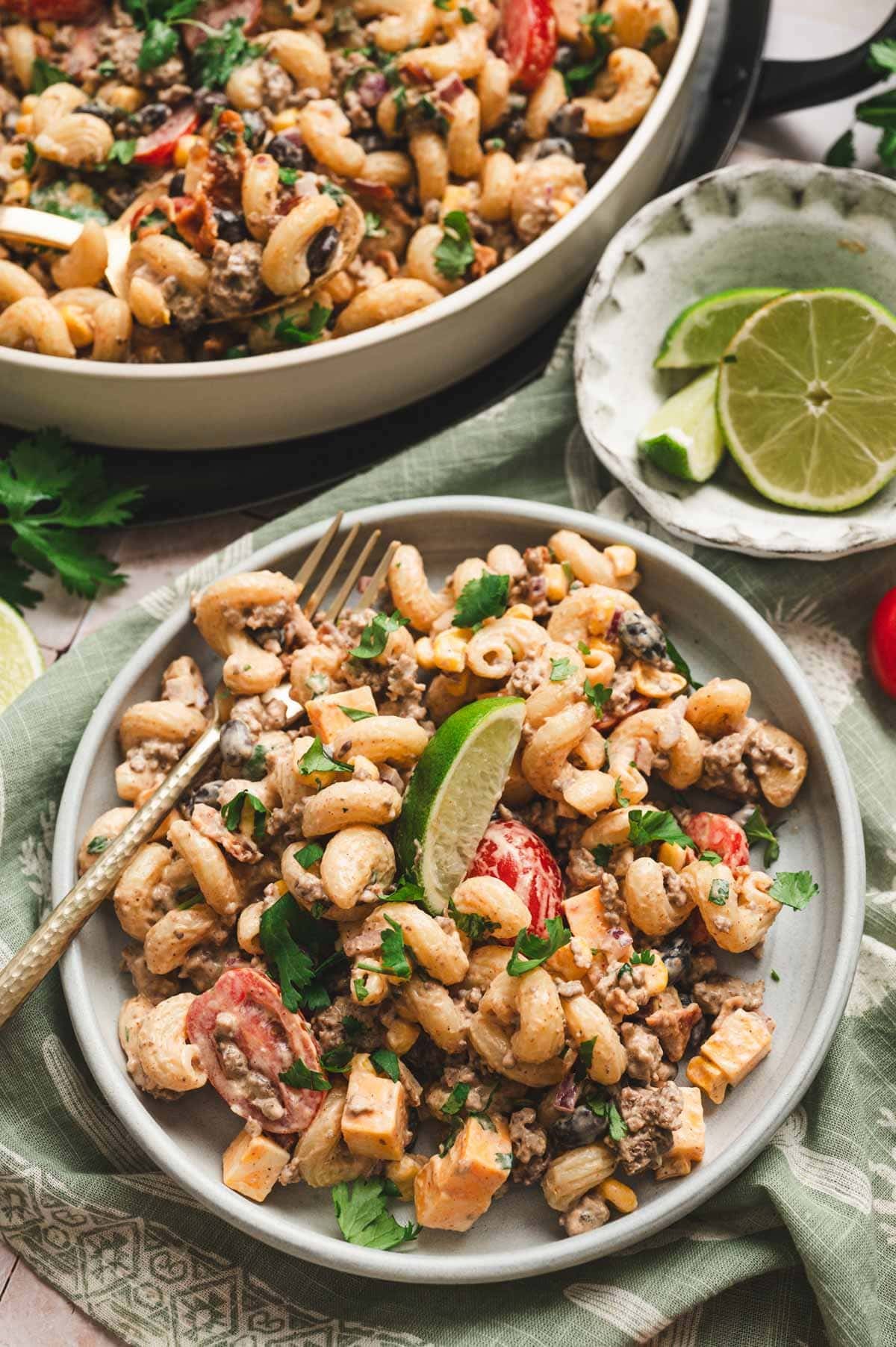 Cowboy pasta salad on a gray plate with a fork.