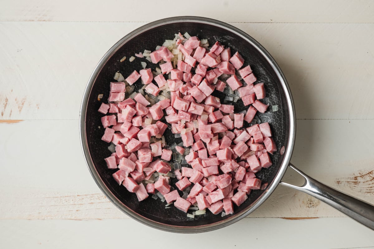 ham and sauteed onion in a skillet