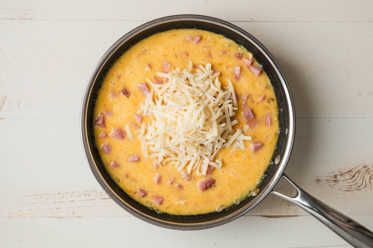 eggs, cheese, and ham in a skillet