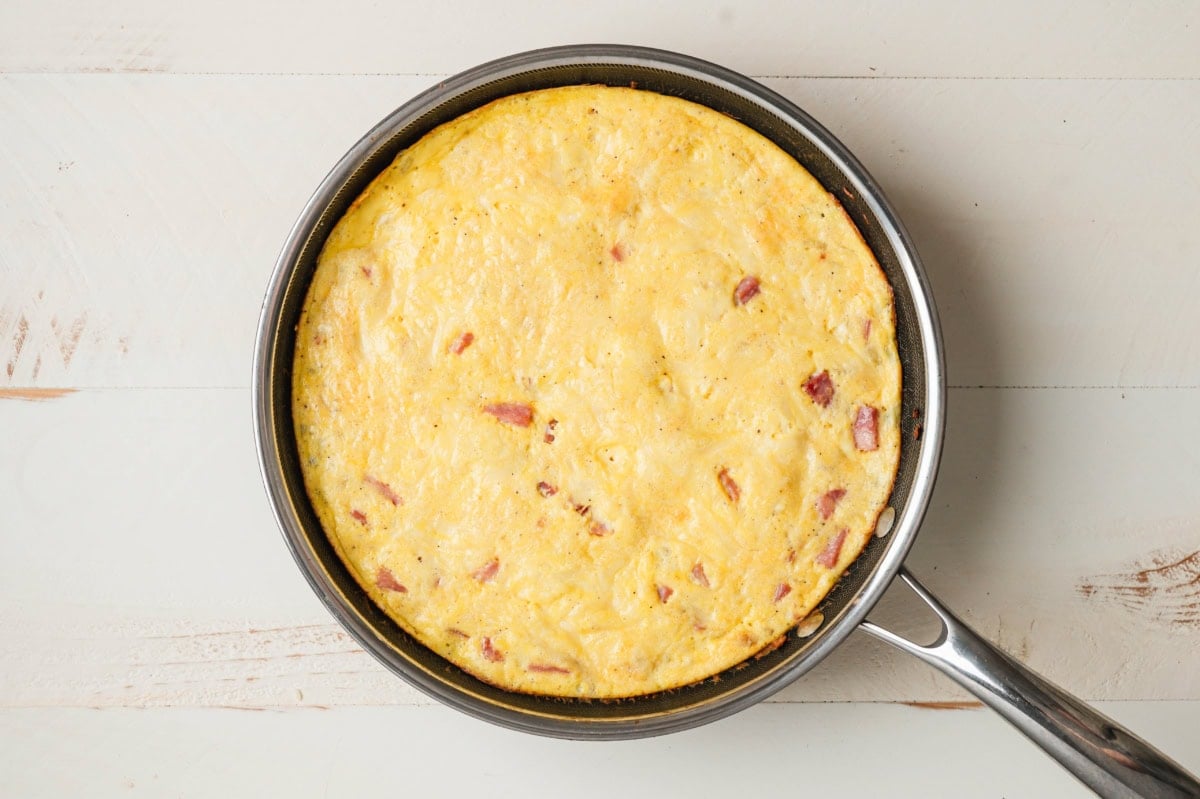 cooked ham and cheese frittata in a skillet