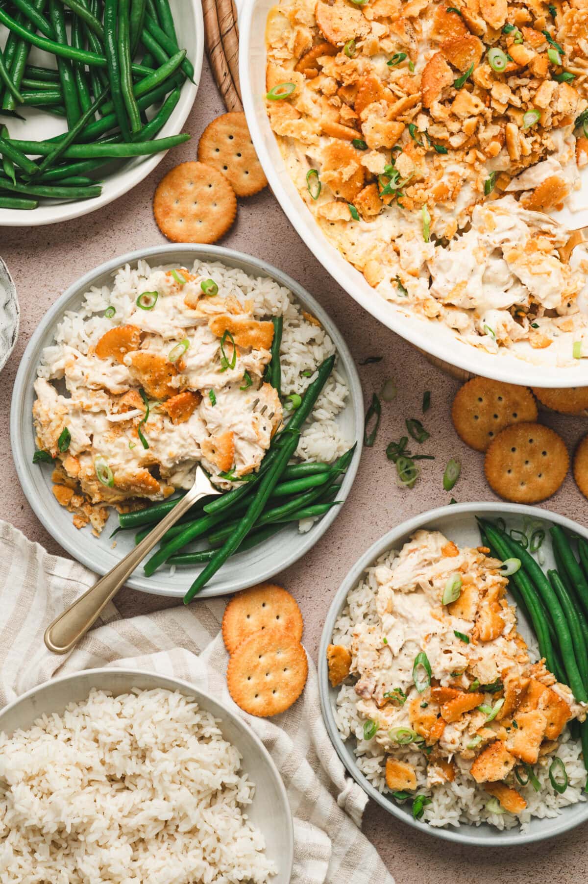 Ritz cracker chicken casserole with rice and green beans served on plates.
