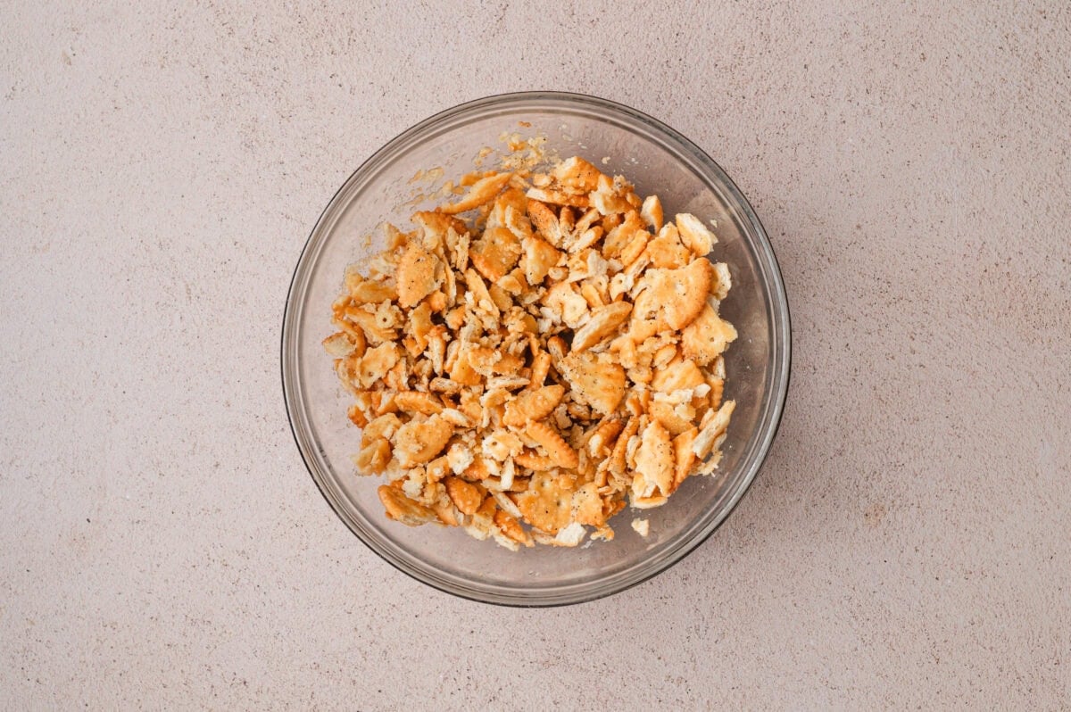 Ritz crackers crumbled in a glass bowl.