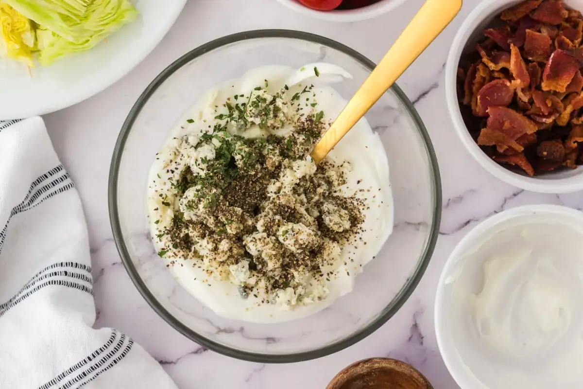 Blue cheese dressing before being mixed in a glass bowl.