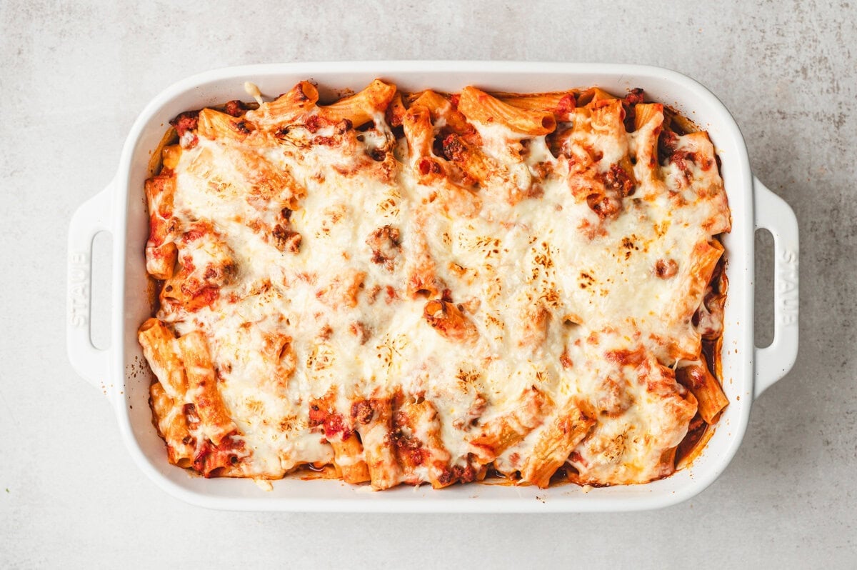 Baked rigatoni in a white casserole dish.