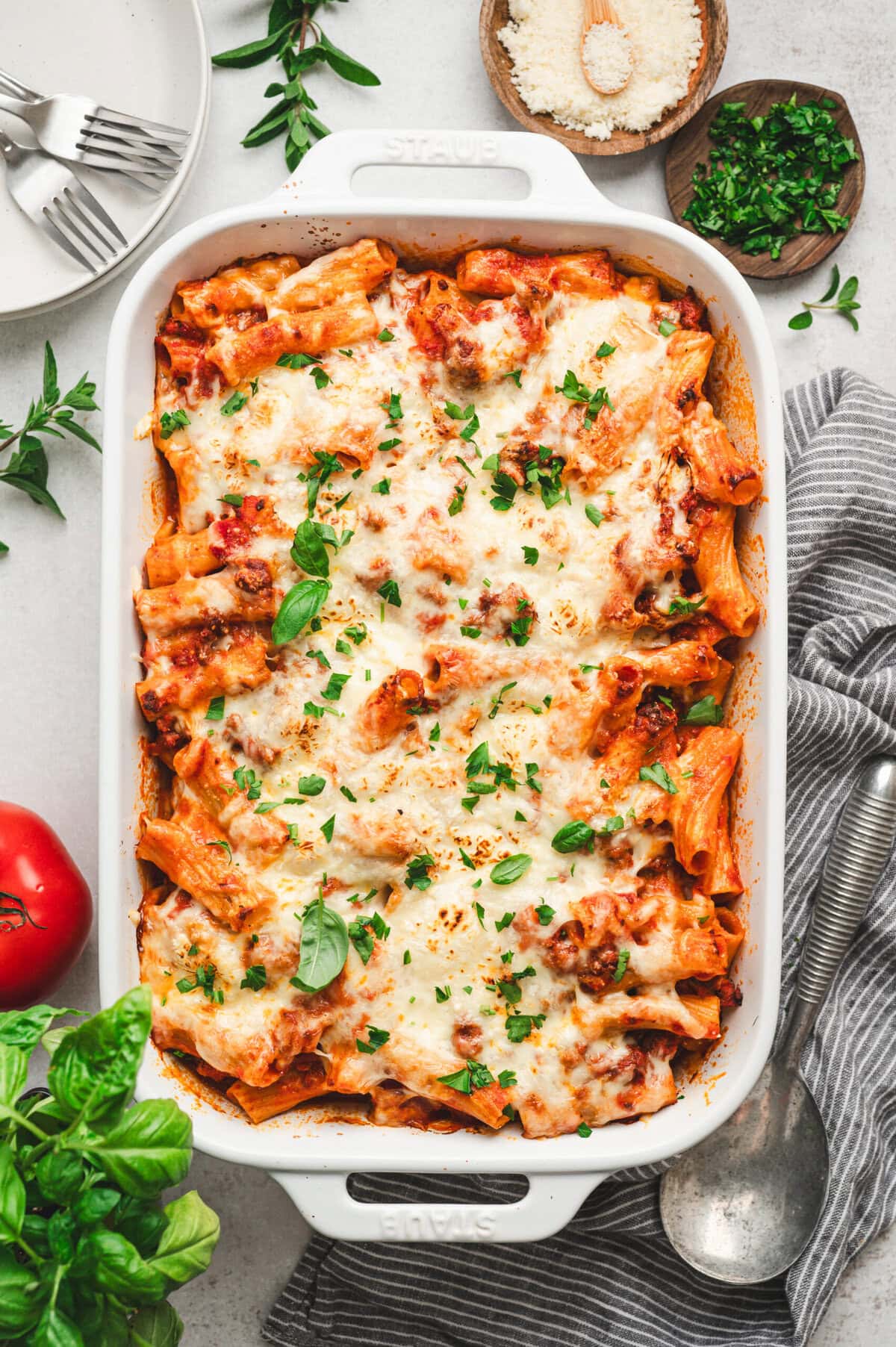 Baked rigatoni in a white casserole dish.