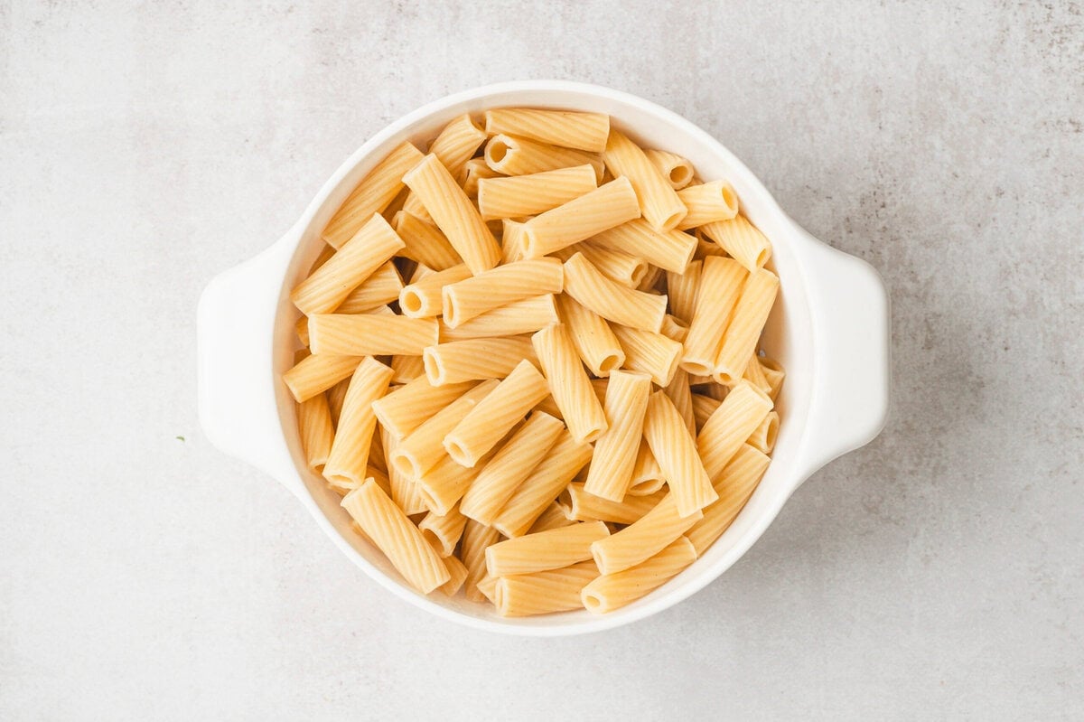 Cooked rigatoni in a white dish.