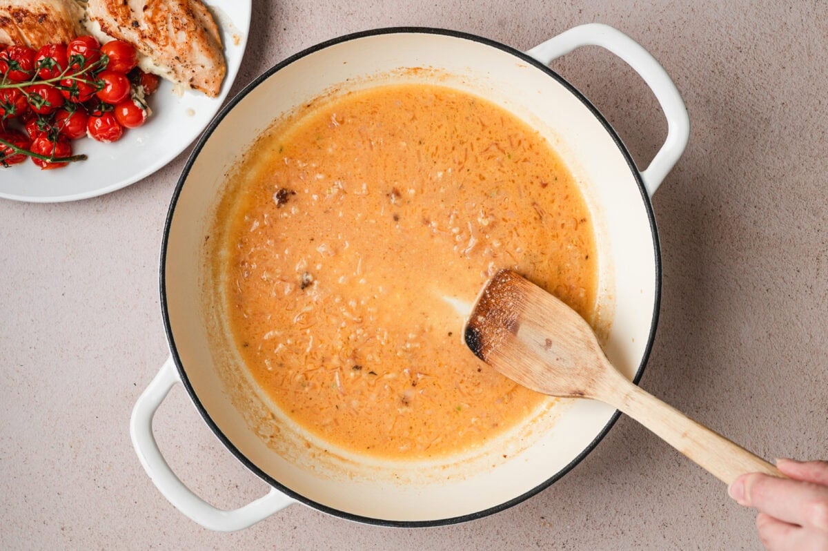 Sauce for Boursin stuffed chicken in a pan.