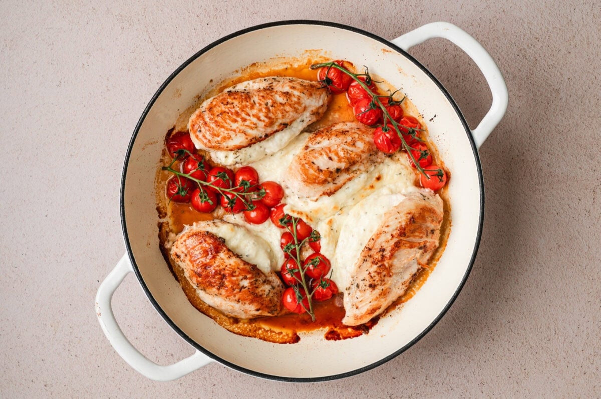 Cooked chicken breasts with boursin cheese and cherry tomatoes.
