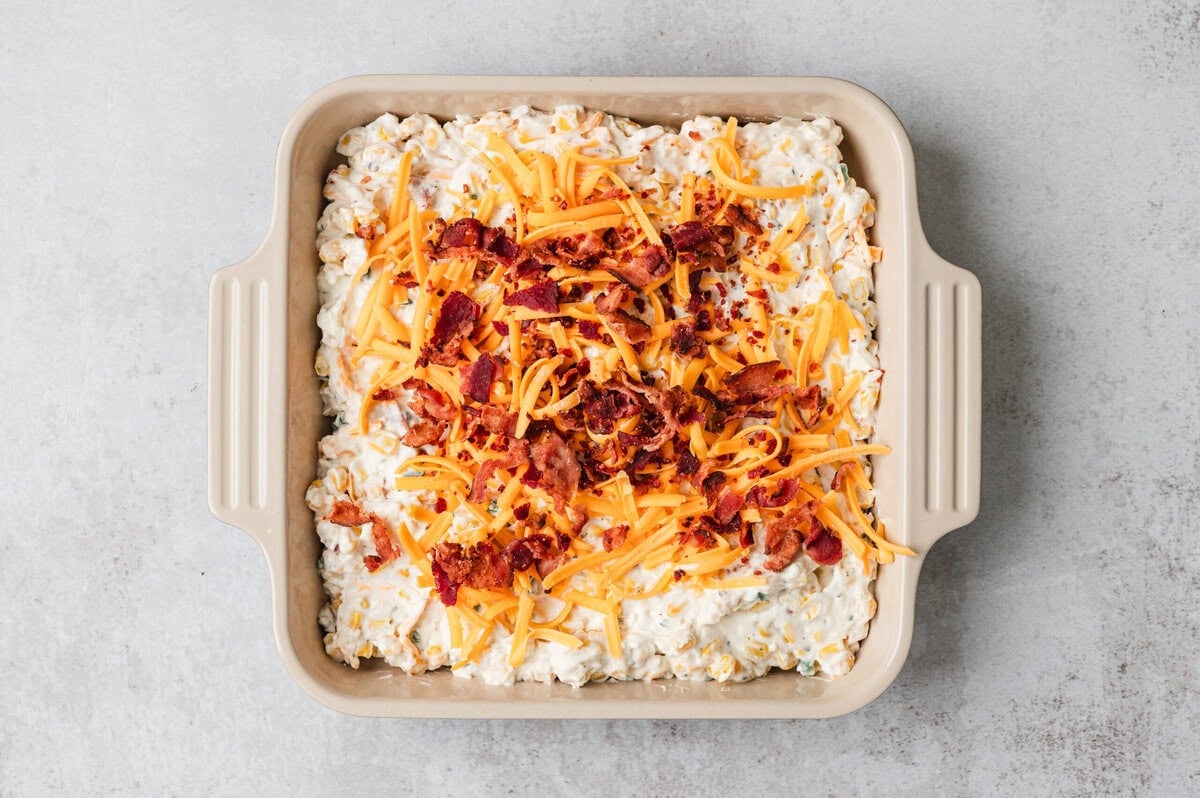 dip topped with cheese and bacon ready to bake
