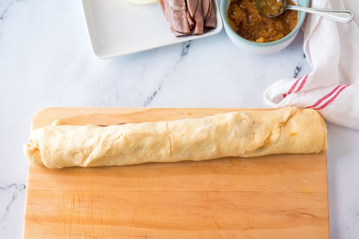 Rolled up unbaked crescent roll dough with caramelized onions, roast beef, and provolone cheese.