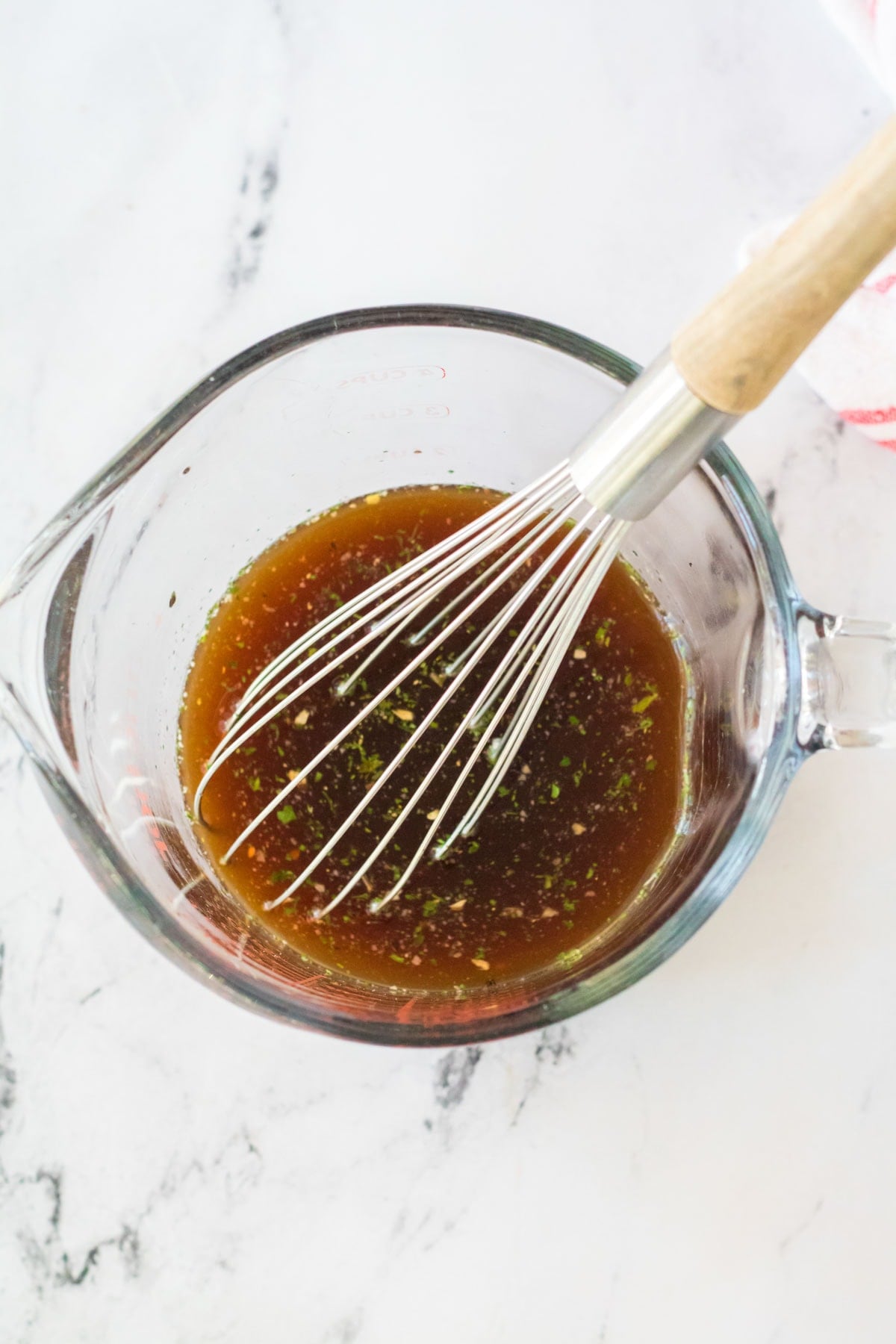 Au jus being whisked in a glass dish