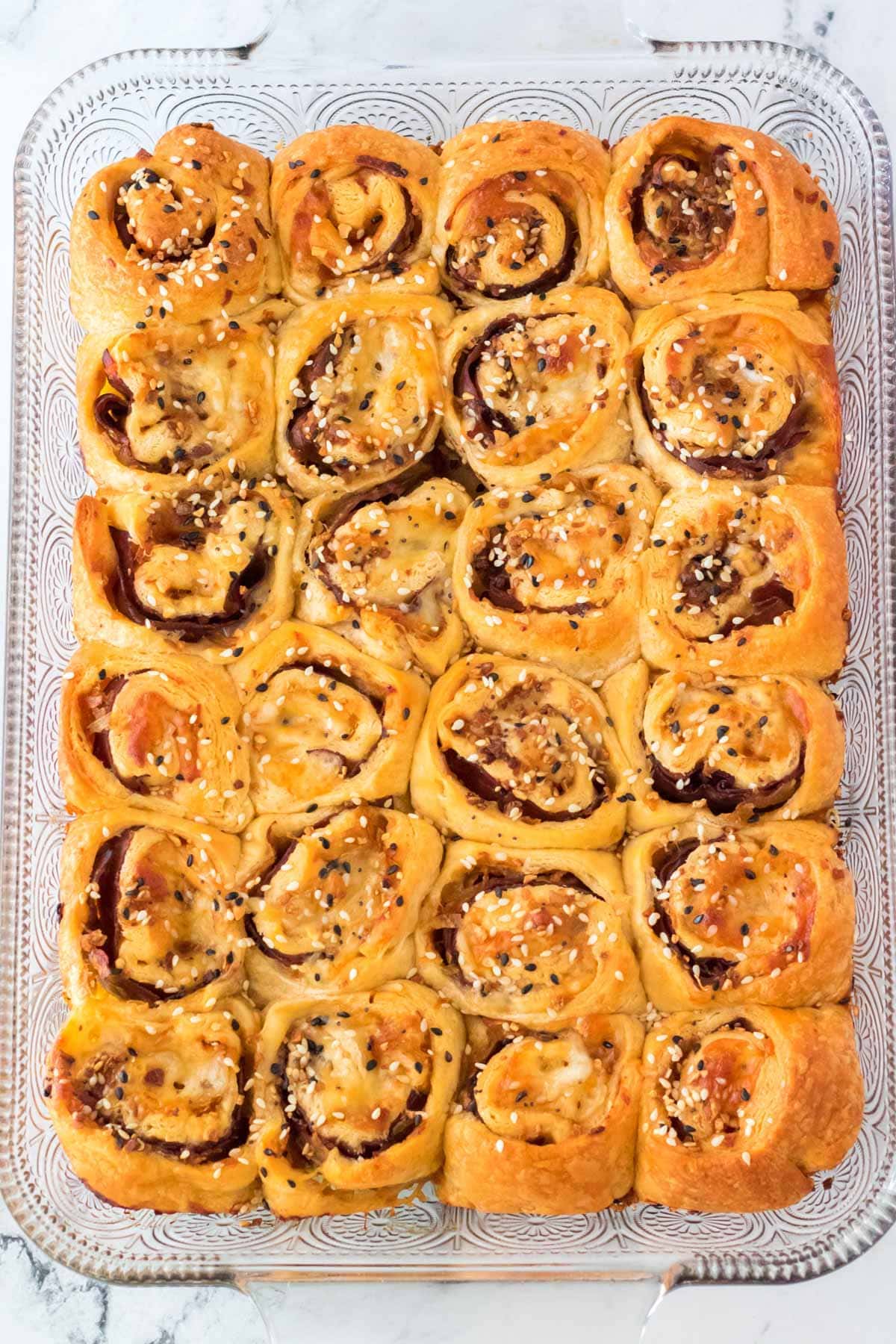 Baked french dip pinwheels in a glass tray.