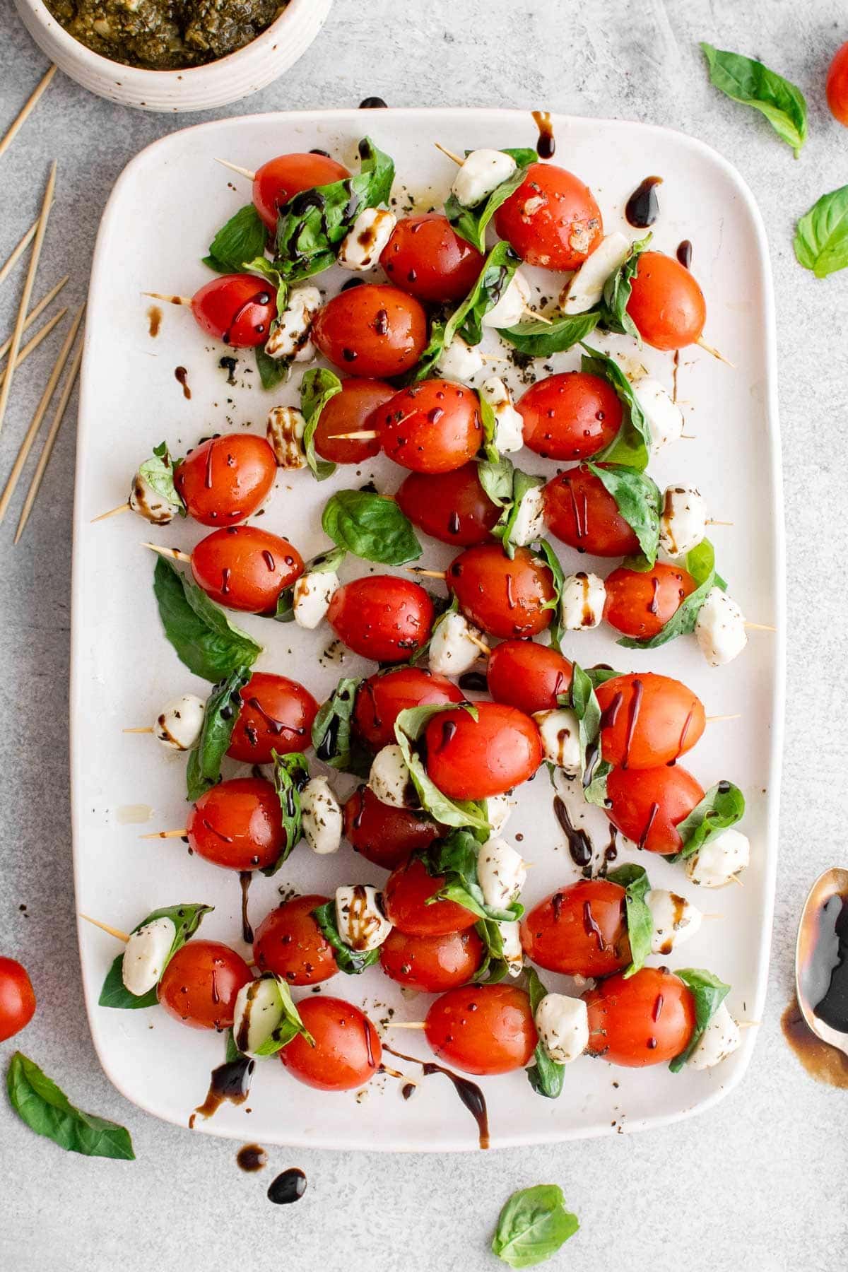 Caprese skewers on a white platter