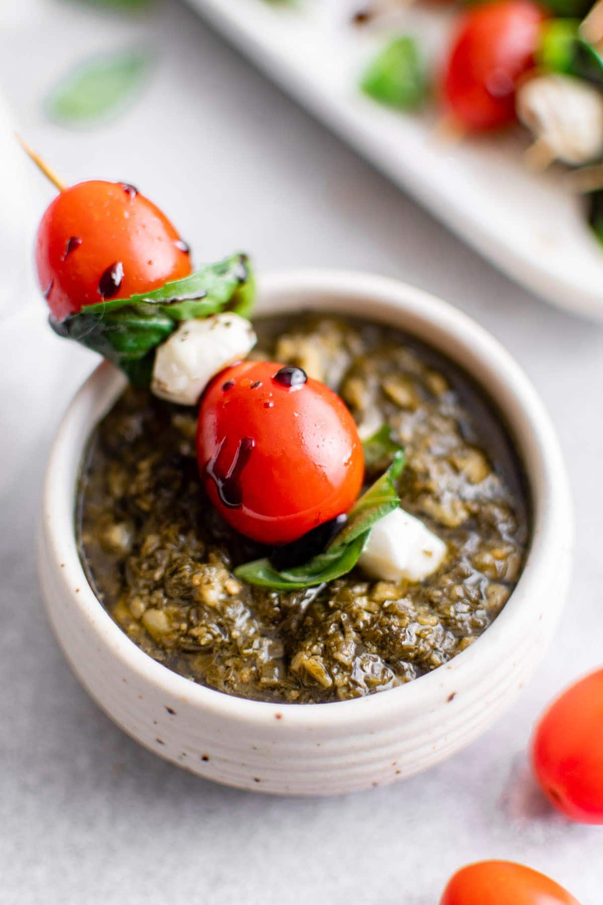 Caprese skewers dipped in pesto