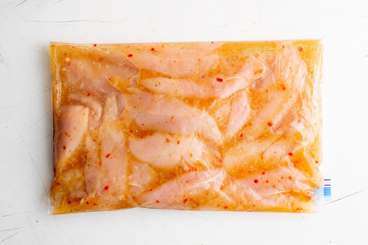 Chicken tenders marinating in a resealable plastic bag