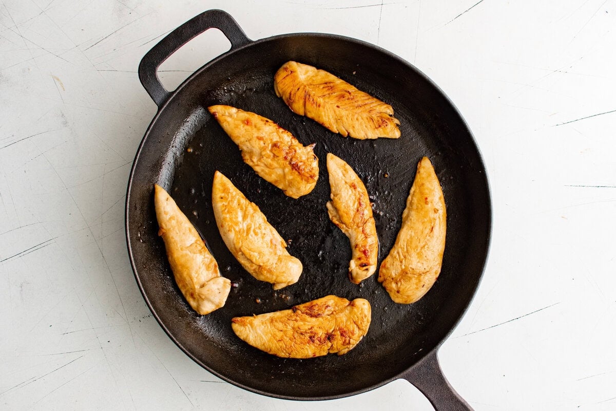 Chicken tenders flipped to show browned, caramelized edges