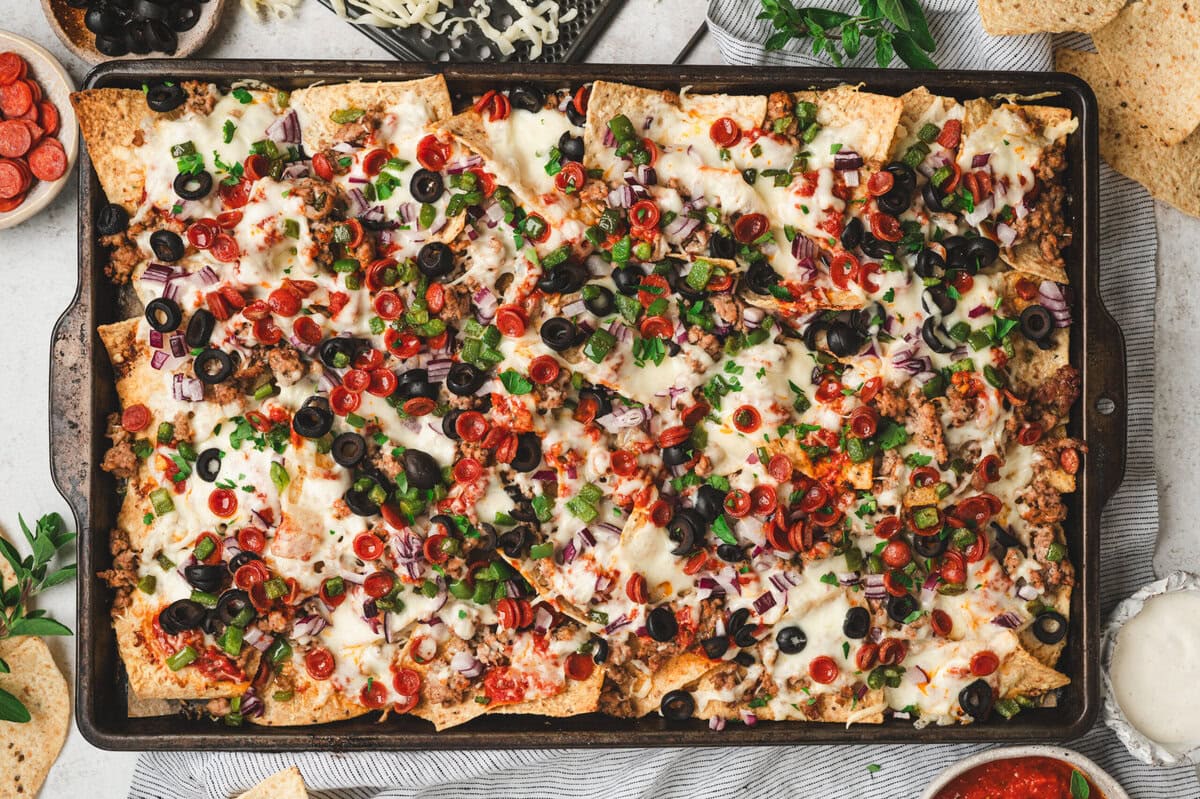 Sheet pan with baked loaded pizza nachos