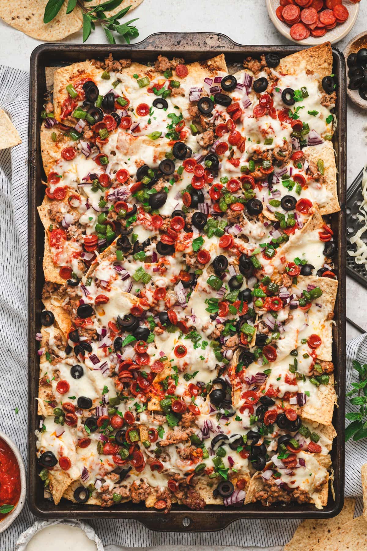 Baked sheet pan of loaded pizza nachos