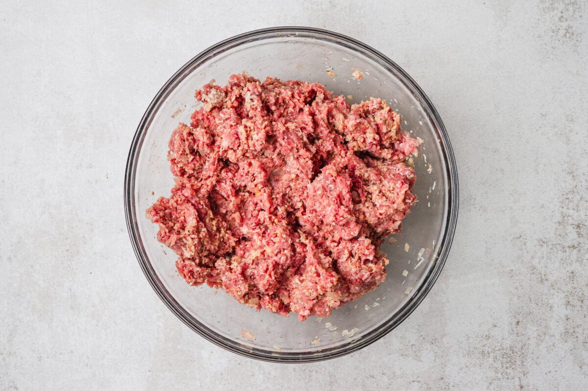 Raw meatloaf mixture in a glass bowl