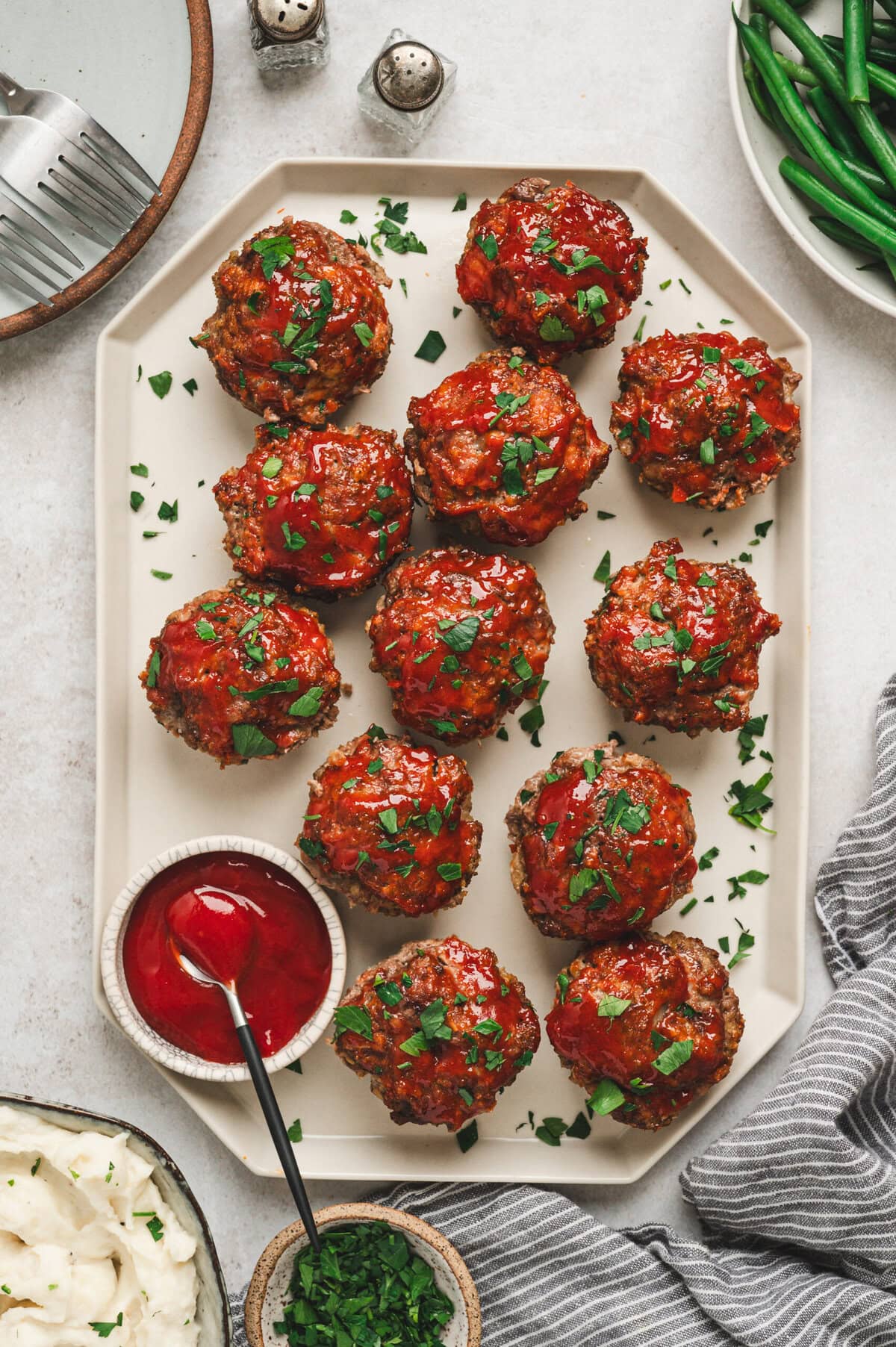 Mini meatloaves with glossy ketchup glaze on a platter