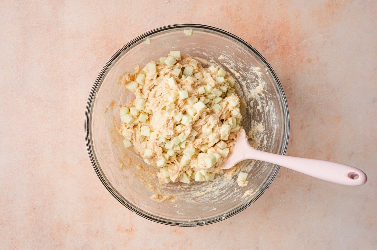 Apple fritter batter in a glass bowl