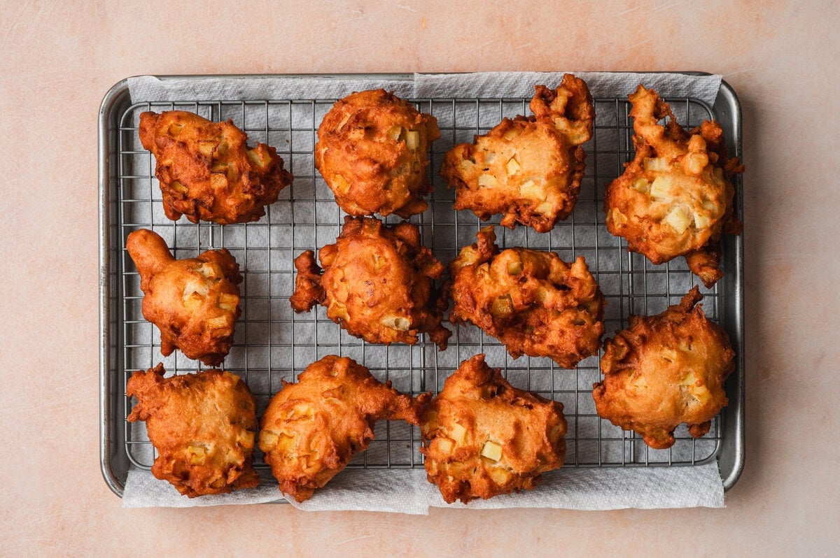 Fried apple fritters on a wire rack