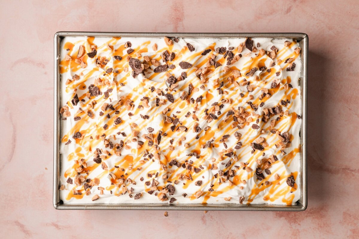 Whipped topping and Heath bits spread over cake