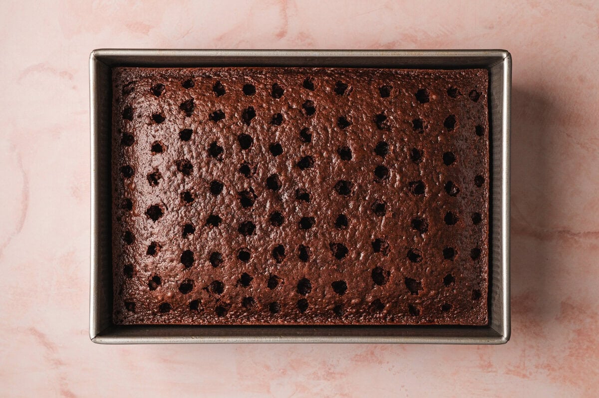 Warm chocolate cake with evenly spaced poked holes