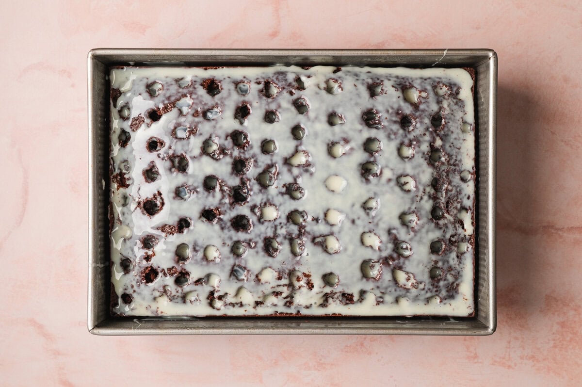 Condensed milk soaking into holes in chocolate cake
