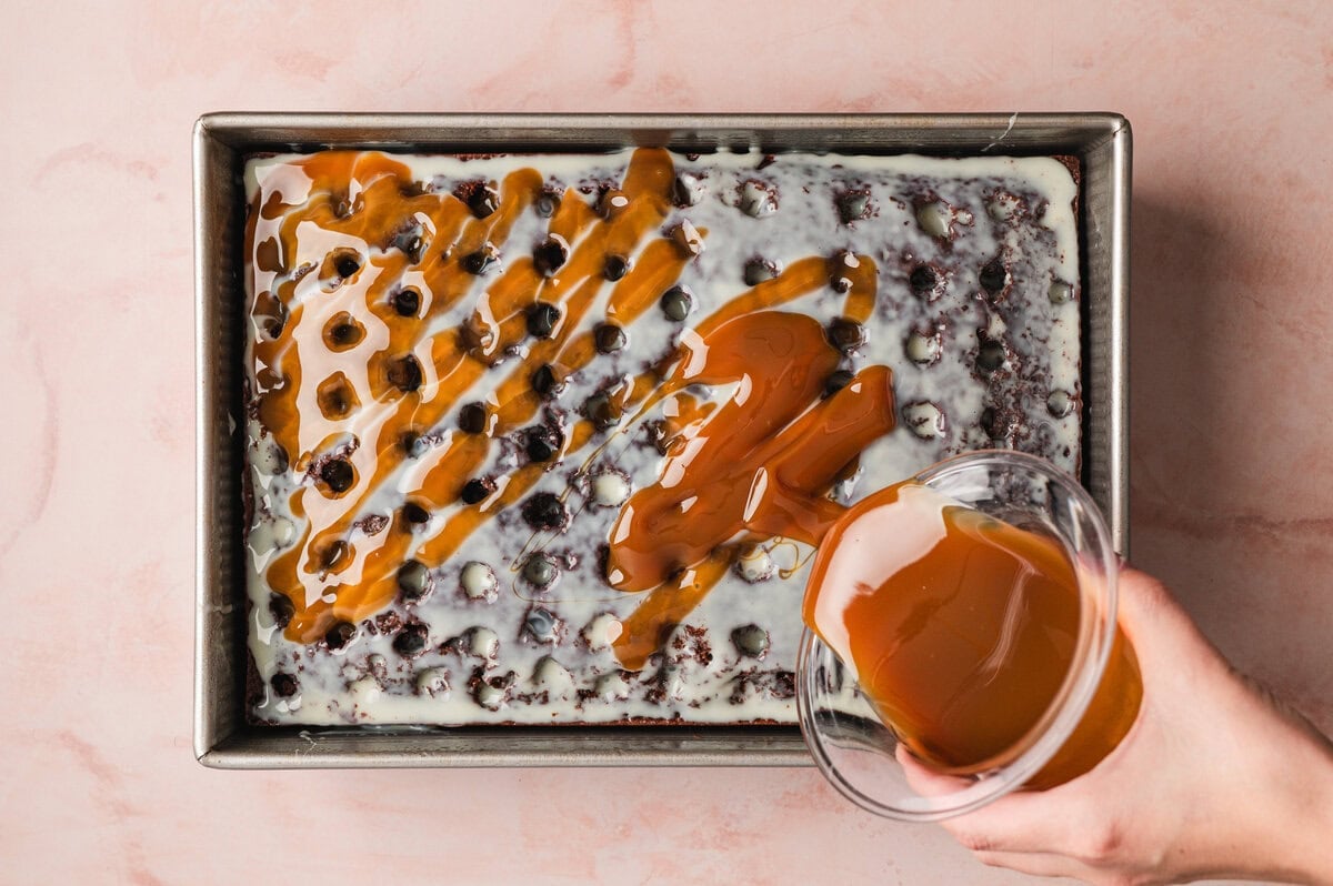 Caramel being poured across cake