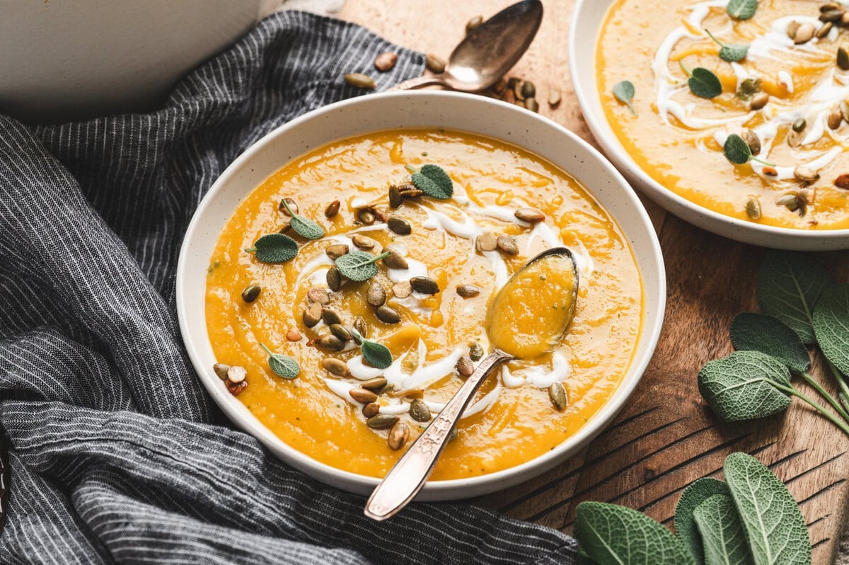 Butternut squash soup with toppings in a bowl with a spoon